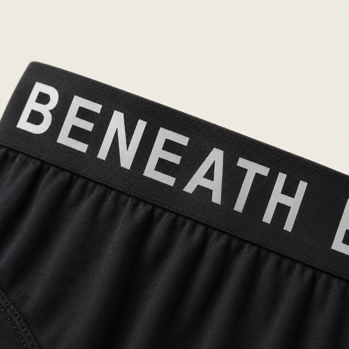 Wide and flat, with bold white BENEATH lettering on black.